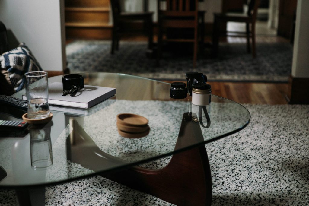 Glass coffee table with minimalistic room setup