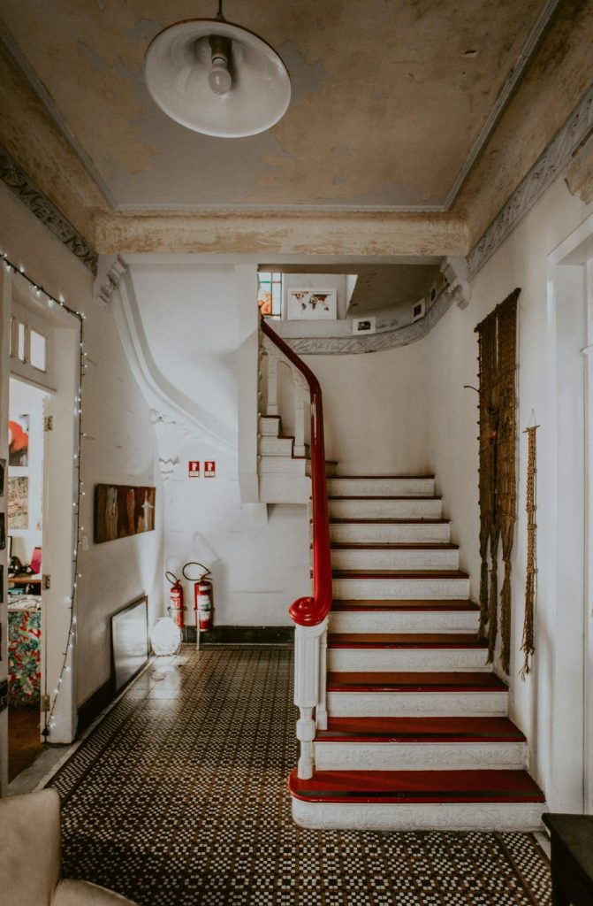 Vintage staircase with red carpet and decor