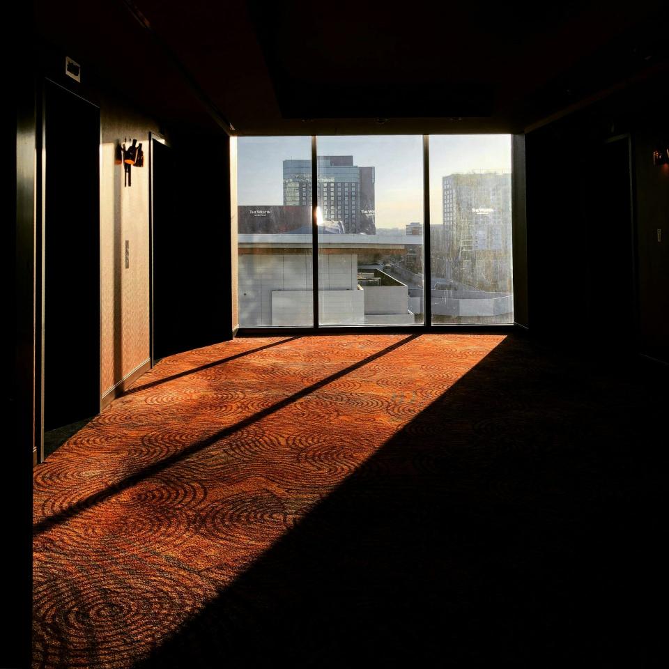 Dim hallway with sunlight through large window